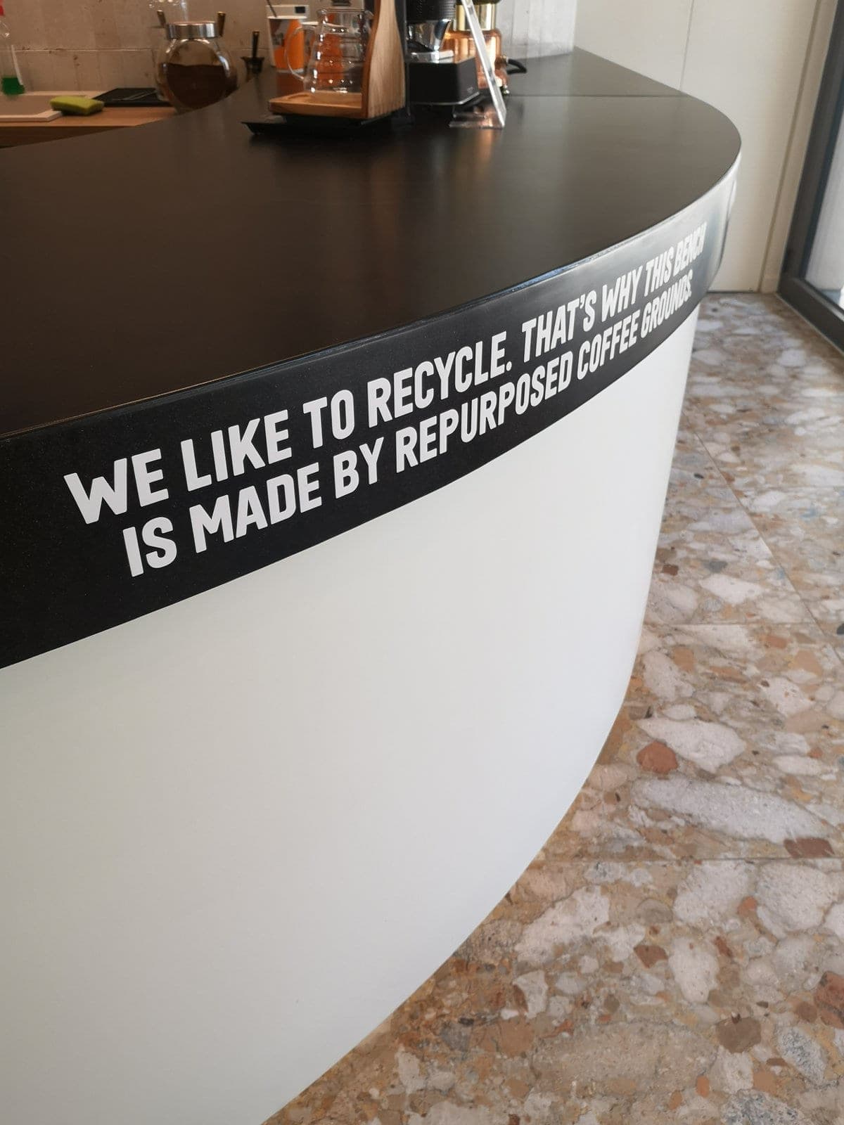 Counter end — repurposed coffee grounds signage detail