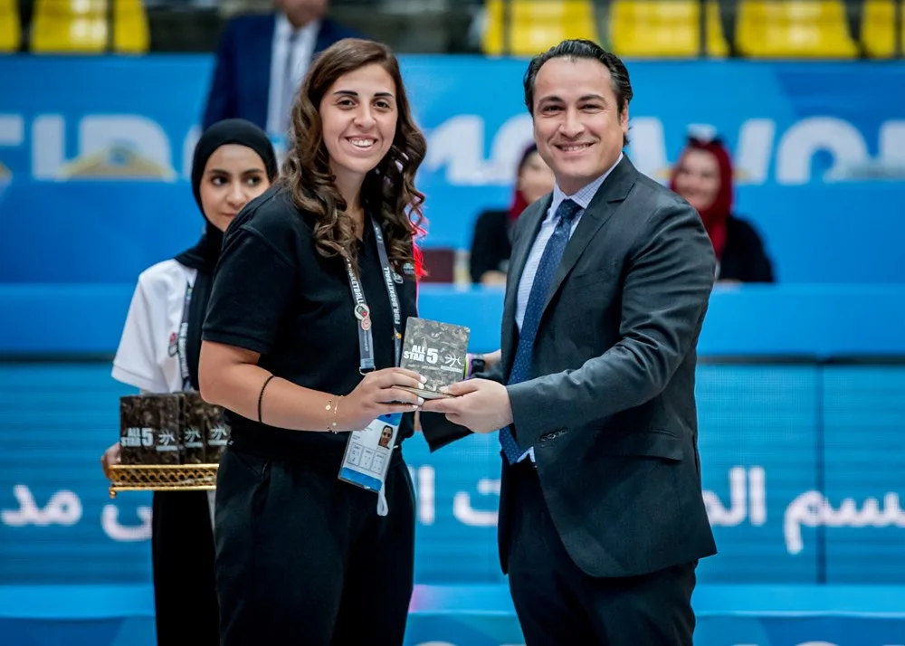 A FIBA official presenting a PHEE Board All-Star 5 award, Jordan 2023